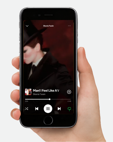 Hand holding a smartphone displaying a music app with a white background
